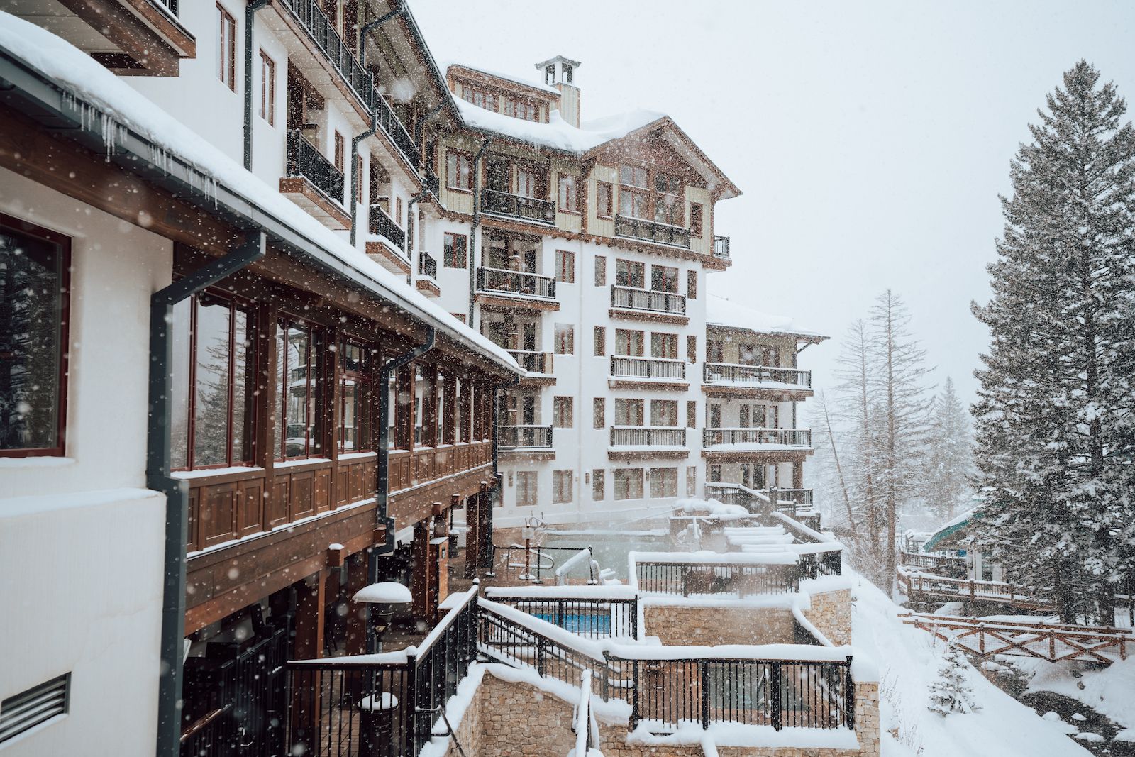 The pool and hot tubs covered in snow at The Blake at Taos Ski Valley