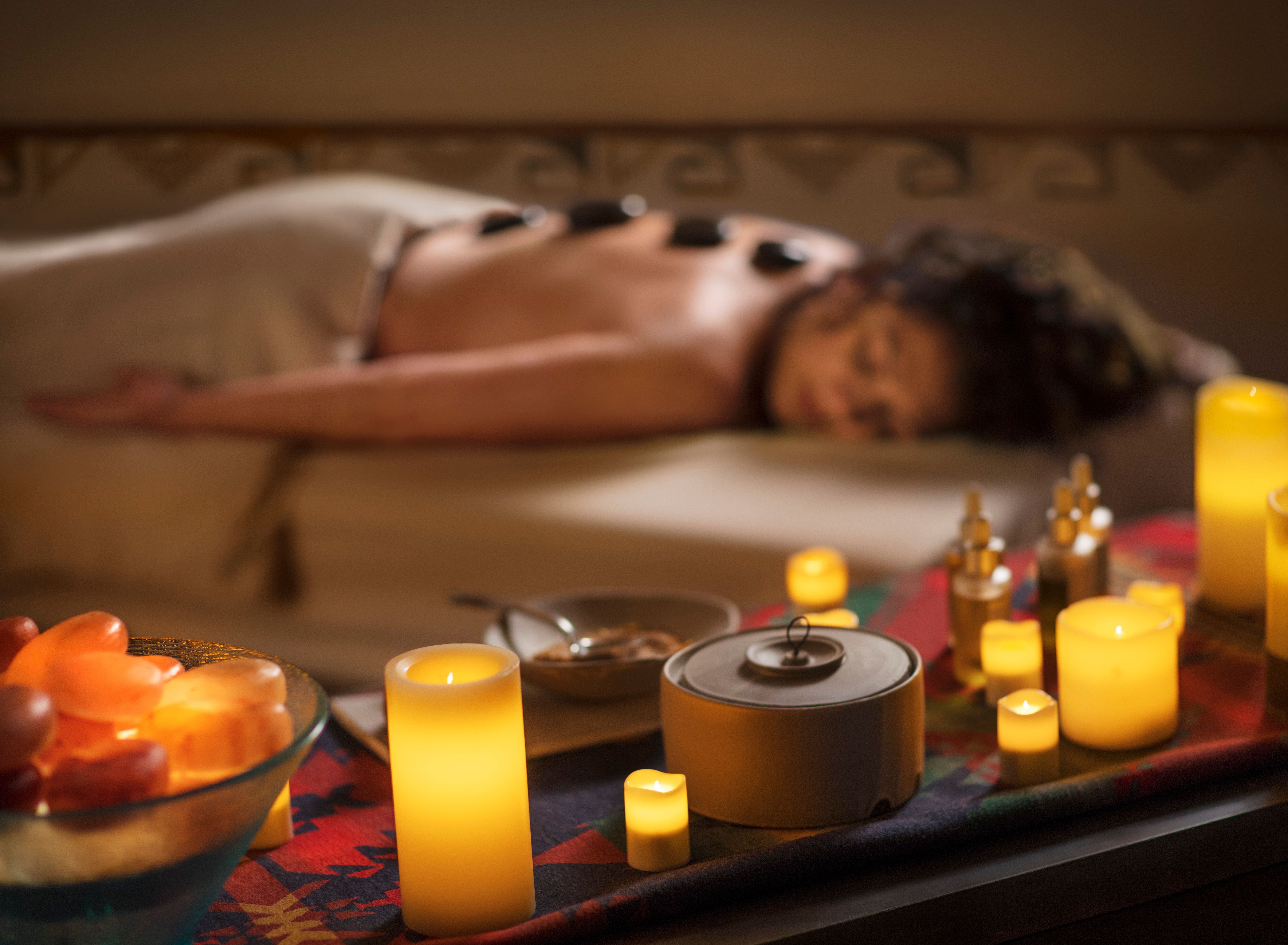 The Blake Spa guest enjoy lava stone treatment in a softly lit room